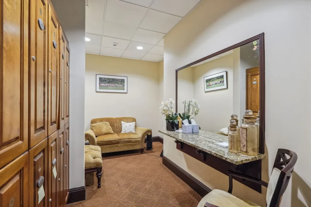 Clubhouse reception area with wood cabinetry, stone counter, and seating